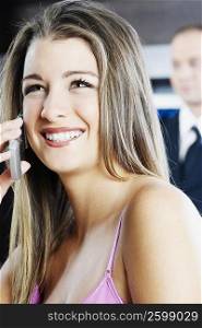 Close-up of a teenage girl talking on a mobile phone and smiling