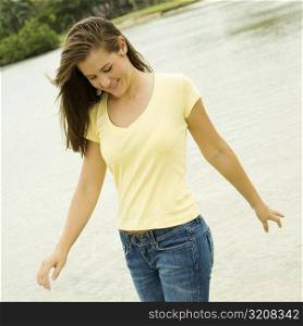 Close-up of a teenage girl walking on the beach looking down