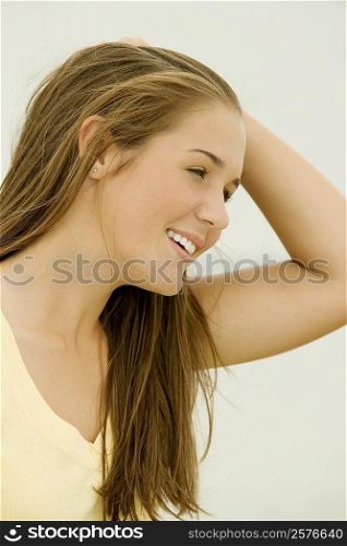 Close-up of a teenage girl with her hand in her hair