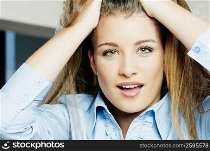 Close-up of a teenage girl with her hands in her hair