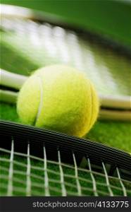 Close-up of a tennis ball and two tennis rackets