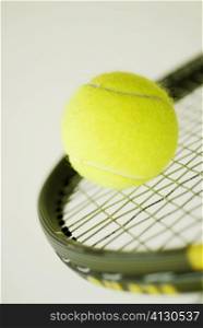 Close-up of a tennis ball on a tennis racket