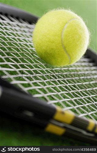 Close-up of a tennis ball on a tennis racket