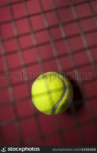 Close-up of a tennis ball with a net