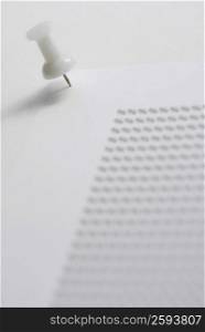 Close-up of a thumbtack on a document