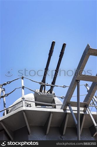 Close-up of a tower with a ship gun. Ship weapon tower. Naval exercises, attack, and defense.