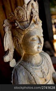 Close up of a traditional stone Buddhist statue.