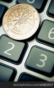 Close-up of a two Euro cent on a calculator