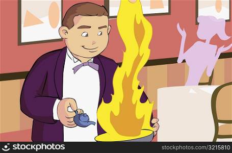 Close-up of a waiter holding a burning frying pan in a restaurant
