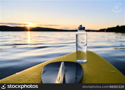Close-up of a water bottle on a paddle board.. Clean water bottle on a paddle board.