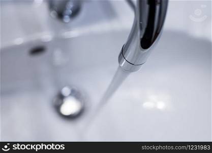 Close up of a water spigot in a clean bathroom. Water saving.