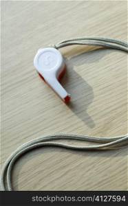 Close-up of a whistle with a cord