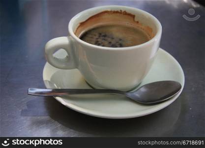 Close up of a white coffee cup with black coffee