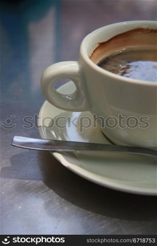 Close up of a white coffee cup with black coffee