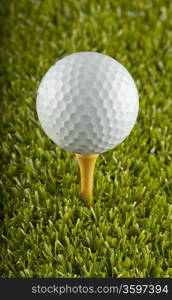 Close up of a white golf ball over a tee in the grass