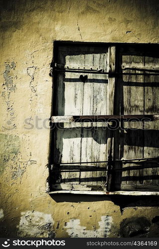 Close-up of a window on a weathered wall