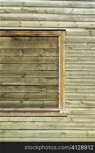 Close-up of a window on a wooden wall