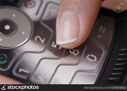 Close-up of a woman&acute;s finger using a mobile phone