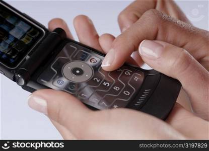Close-up of a woman&acute;s finger using a mobile phone