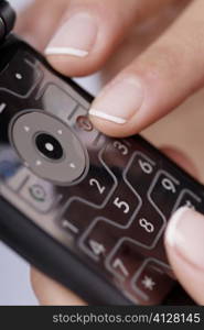 Close-up of a woman&acute;s finger using a mobile phone