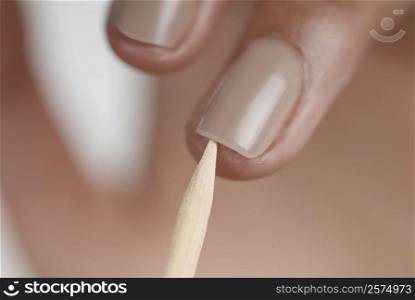 Close-up of a woman&acute;s hand giving herself a manicure