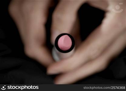 Close-up of a woman&acute;s hand holding a lipstick