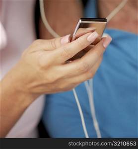 Close-up of a woman&acute;s hand holding an MP3 player