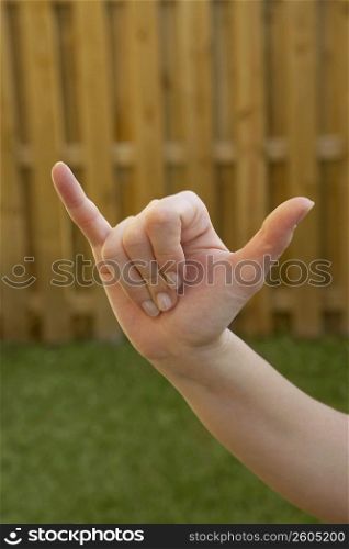 Close-up of a woman&acute;s hand making a shaka sign