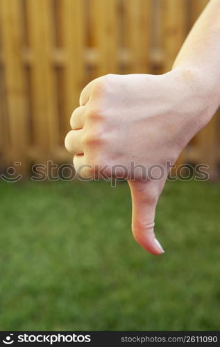 Close-up of a woman&acute;s hand making a thumbs down sign