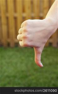 Close-up of a woman&acute;s hand making a thumbs down sign