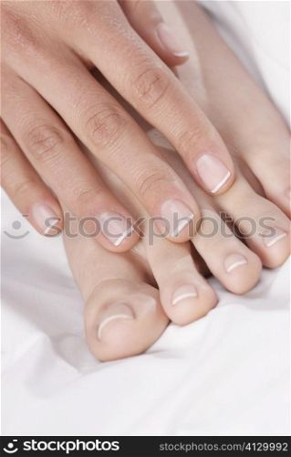 Close-up of a woman&acute;s hand touching her feet