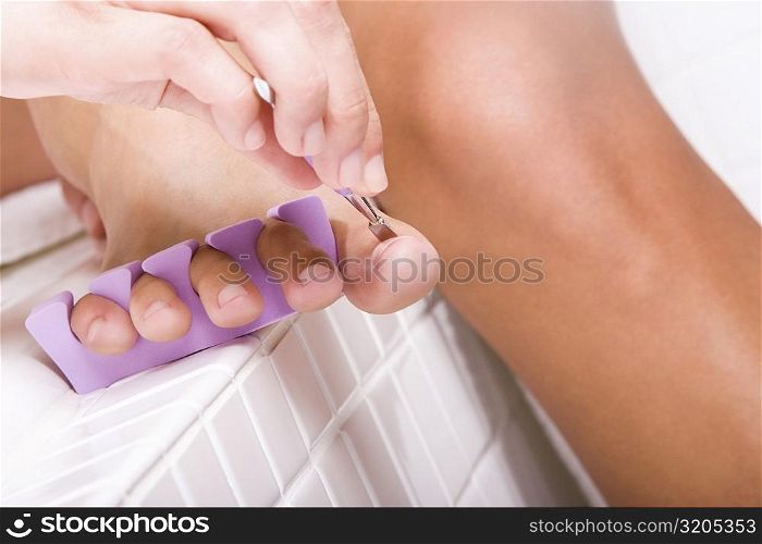 Close-up of a woman&acute;s hand using a nail file