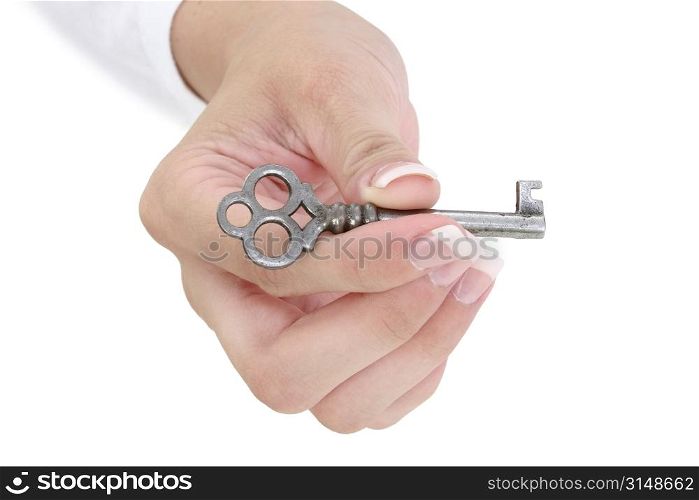 Close up of a woman&acute;s manicured hand holding a skeleton key.