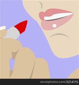 Close-up of a woman applying lipstick