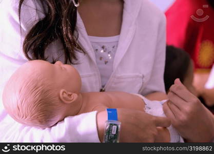 Close-up of a woman carrying a doll