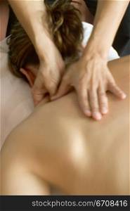 Close-up of a woman getting a back massage from a massage therapist