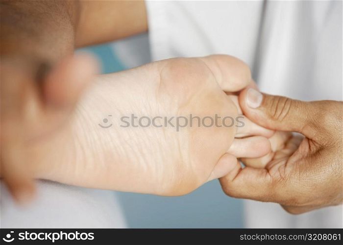 Close-up of a woman getting a foot massage