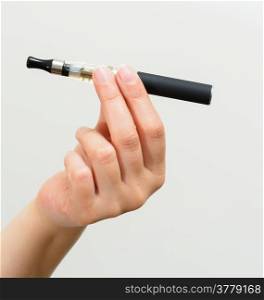 Close up of a woman hand holding an electronic cigarette