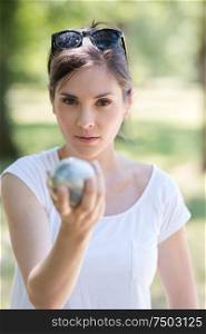 close up of a woman playing petanque