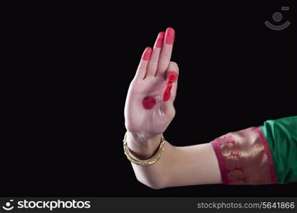 Close-up of a woman&rsquo;s hand making a Bharatanatyam gesture called Arala on black background