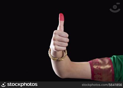 Close-up of a woman&rsquo;s hand making a Bharatanatyam gesture called Shikhara on black background