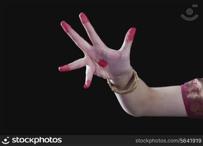 Close-up of a woman&rsquo;s hand making Bharatanatyam gesture called Alapadma on black background