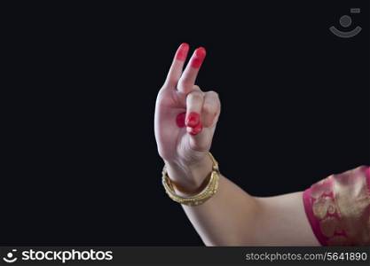 Close-up of a woman&rsquo;s hand making Bharatanatyam gesture called Bhramara on black background