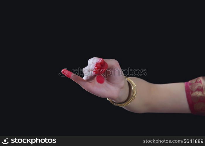 Close-up of a woman&rsquo;s hand making Bharatanatyam gesture called Chatura on black background