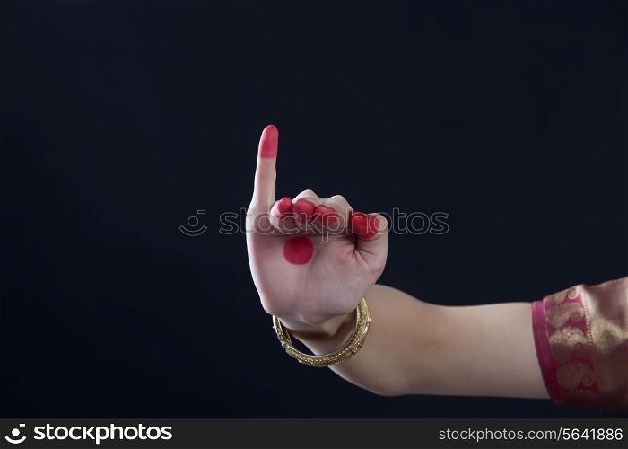 Close-up of a woman&rsquo;s hand making Bharatanatyam gesture called Hamsapaksha on black background