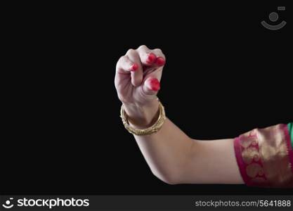 Close-up of a woman&rsquo;s hand making Bharatanatyam gesture called Kangula on black background