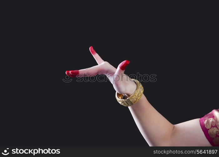 Close-up of a woman&rsquo;s hand making Bharatanatyam gesture called Mrigashirsha on black background