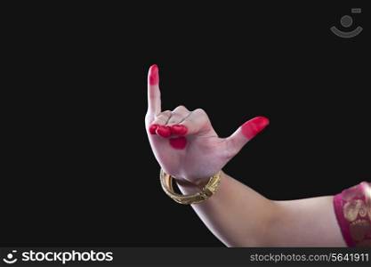 Close-up of a woman&rsquo;s hand making Bharatanatyam gesture called Mrigashirsha on black background