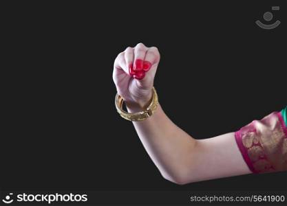 Close-up of a woman&rsquo;s hand making Bharatanatyam gesture called Mukula on black background