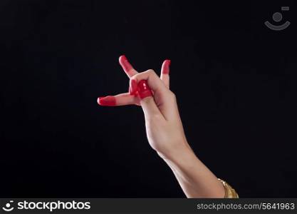Close-up of a woman&rsquo;s hand making Bharatanatyam gesture on black background